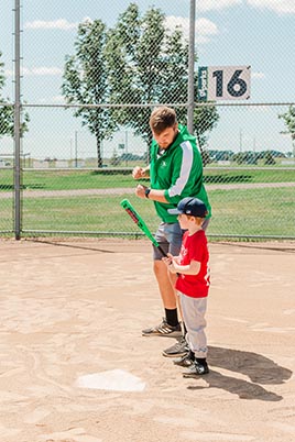 Ferden coaching baseball player