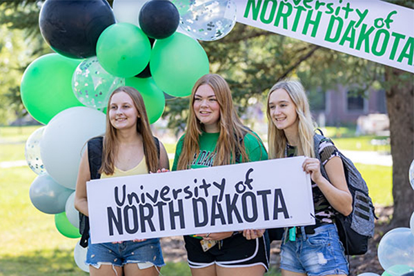 Students Holding UND Sign