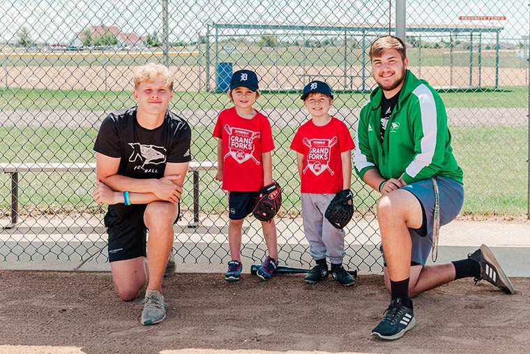 Schaffner and Ferden with young baseball players 